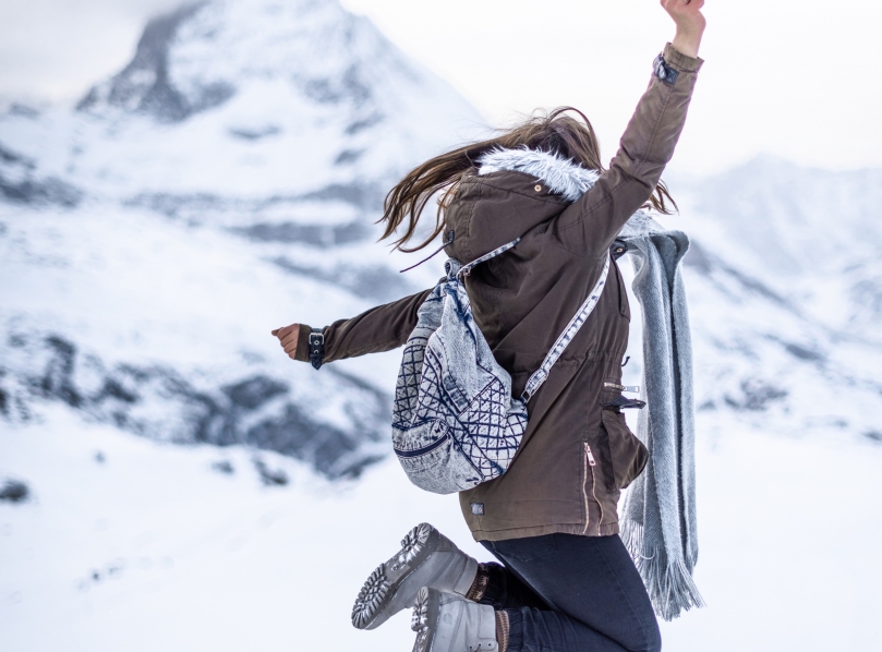 Girl jumping in front of Matterhorn