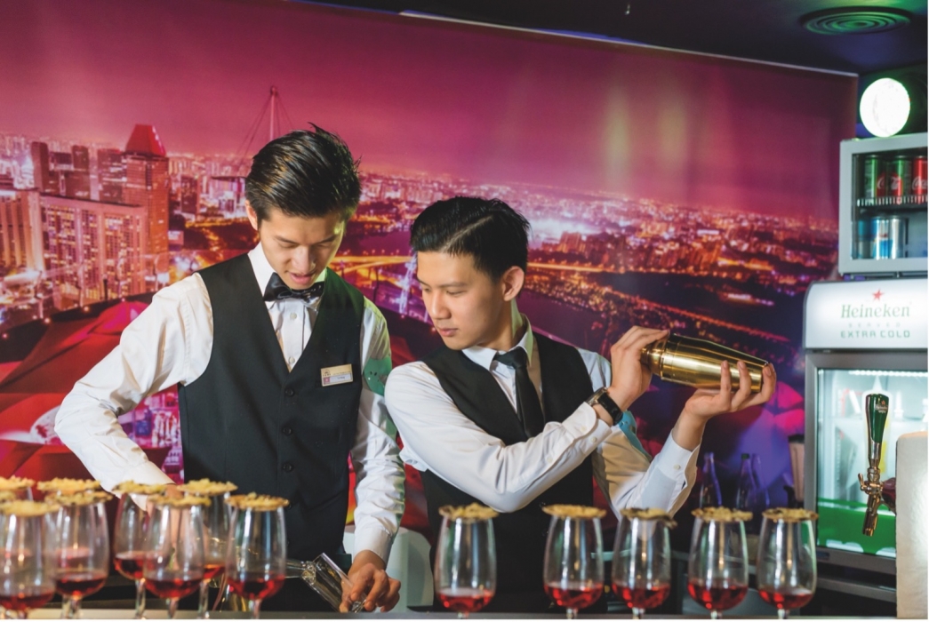 Students working the bar at their own event