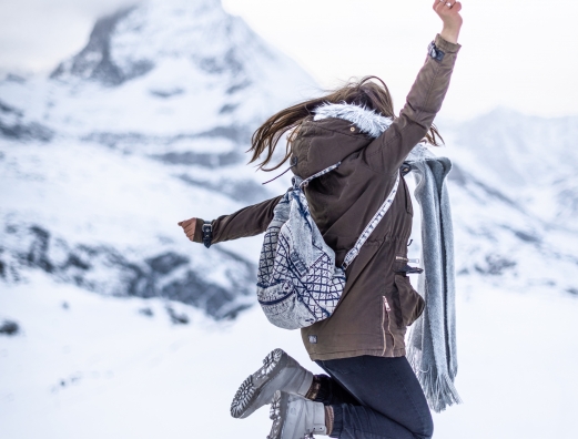 Girl jumping in front of Matterhorn